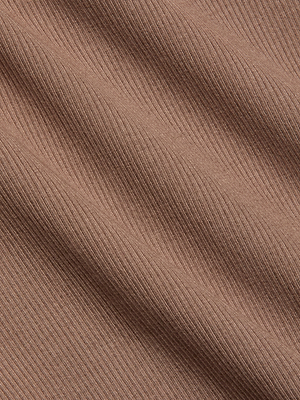 Close-up of light brown ribbed fabric with diagonal lines and a soft texture, featuring fine ridges and a smooth surface—perfect for the sculpted fit of the Nica Scoopneck Bodysuit.