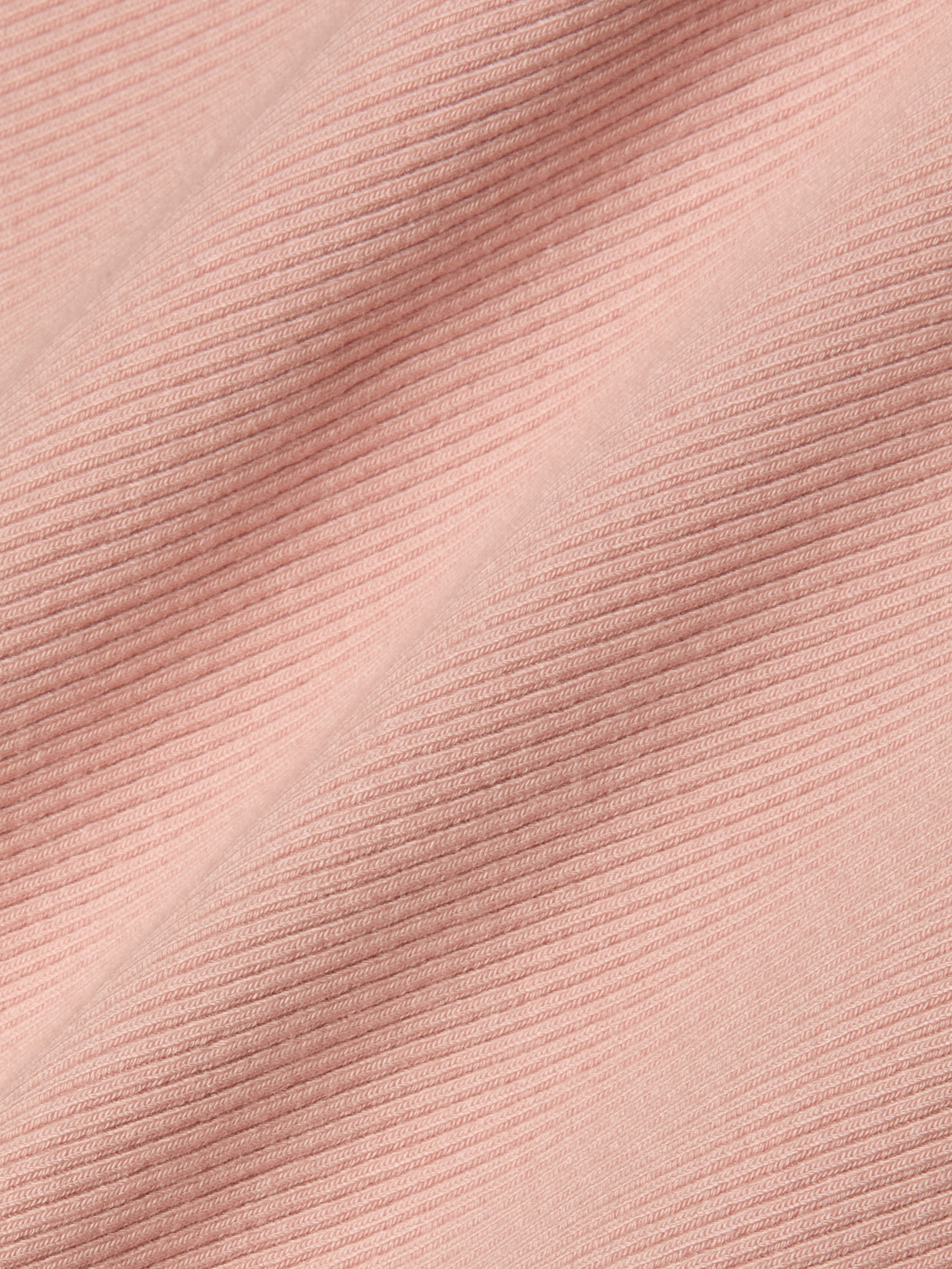 Close-up of light pink, high-stretch rib fabric with diagonal textured lines that form a raised and flat pattern across the material—an ideal choice for the Nica Scoopneck Bodysuit.