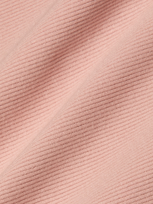 Close-up of light pink stretch rib fabric with diagonal lines and subtle shadows, highlighting the soft textured material of the Nica Scoopneck Bodysuit.