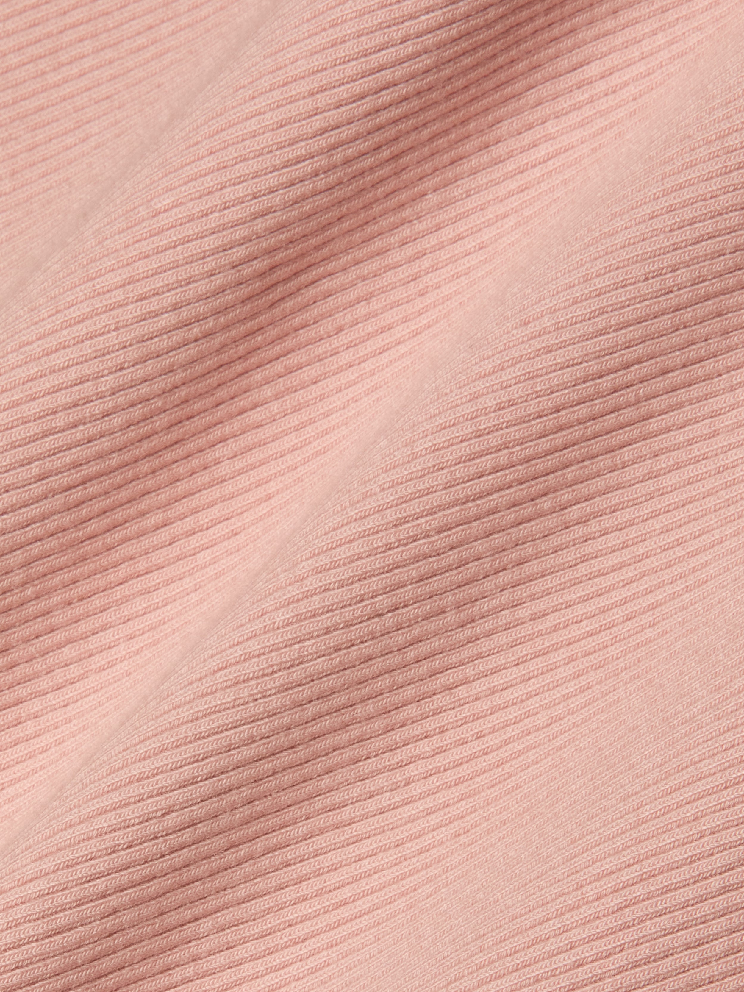 Close-up of light pink, high-stretch rib fabric with diagonal textured lines that form a raised and flat pattern across the material—an ideal choice for the Nica Scoopneck Bodysuit.