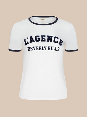 The Tommie Crewneck Tee is a white short-sleeve Supima cotton T-shirt with black trim and bold LAGENCE BEVERLY HILLS text on the front.