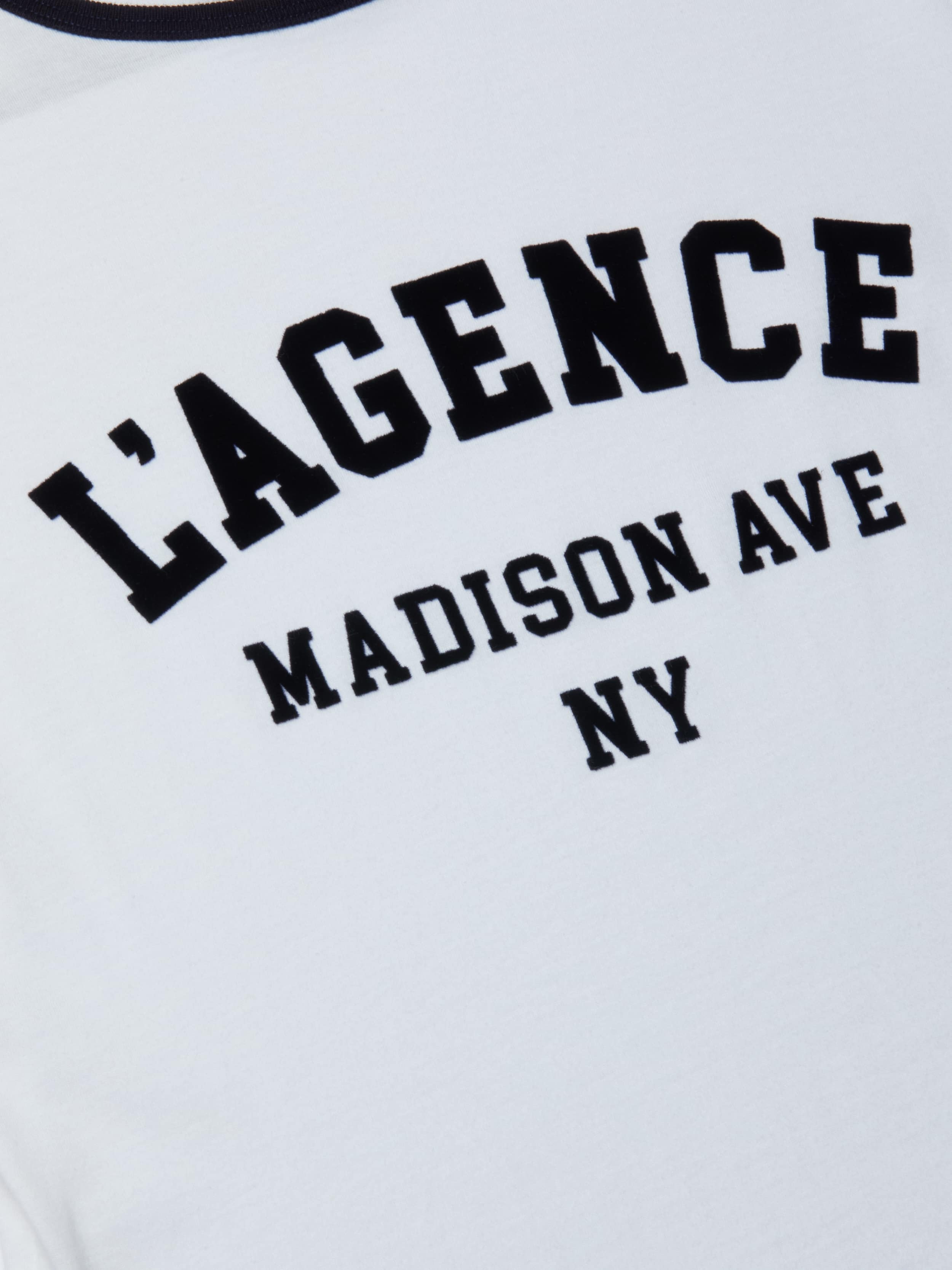 The Tommie Crewneck Tee is crafted from soft Supima cotton in white and features black collegiate-style LAGENCE MADISON AVE NY text in a relaxed fit.