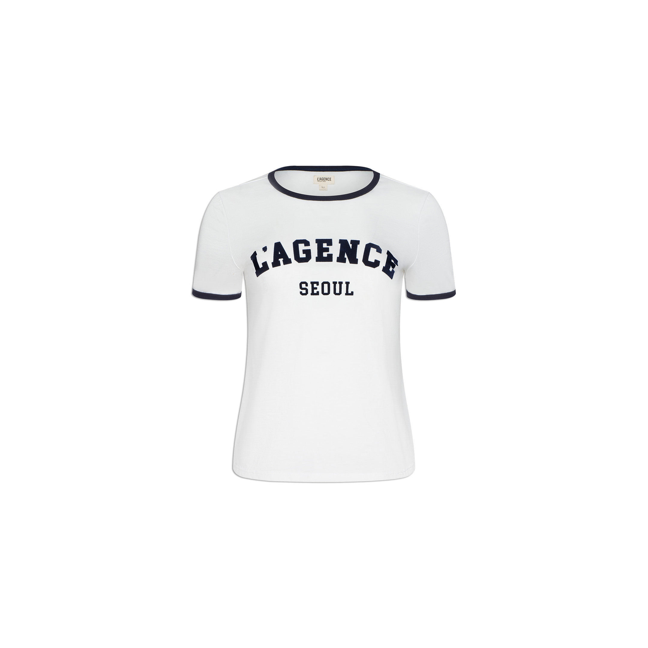 The Tommie Crewneck Tee is a white short-sleeve ringer shirt with black trim on the collar and sleeves. Made from soft Supima cotton for a relaxed fit, it features bold black “LAGENCE” text above “SEOUL” on the front. Displayed against a plain white background.
