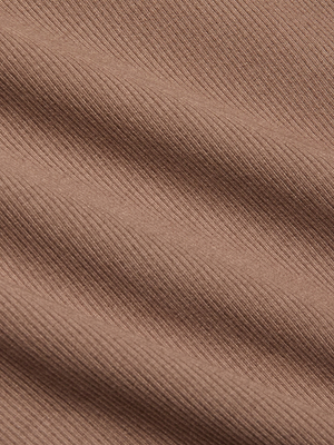 Close-up of the Adira Scoopneck Tank in light brown, featuring fitted ribbed fabric with diagonal ridges and gentle folds that highlight its texture and soft shadows.