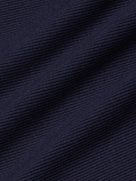 Close-up of the Adira Scoopneck Tank in dark navy blue stretch rib fabric, featuring diagonal textured lines with fine horizontal ridges and subtle light reflections.