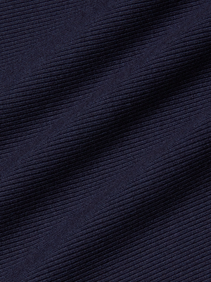 Close-up of dark navy blue ribbed fabric with diagonal lines and soft folds, showcasing the structured texture perfect for the Adira Scoopneck Tank—a fitted essential style.