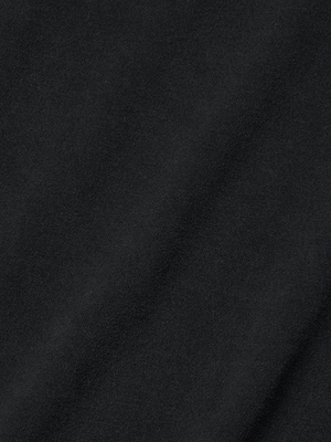Close-up of the Daria Oversized Cropped Tee in black, crafted from soft Supima cotton with a smooth texture and subtle diagonal folds on its surface.