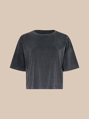 The Daria Oversized Cropped Tee is a loose-fitting, charcoal gray T-shirt with a crew neckline, crafted from soft Supima cotton and shown against a beige background.