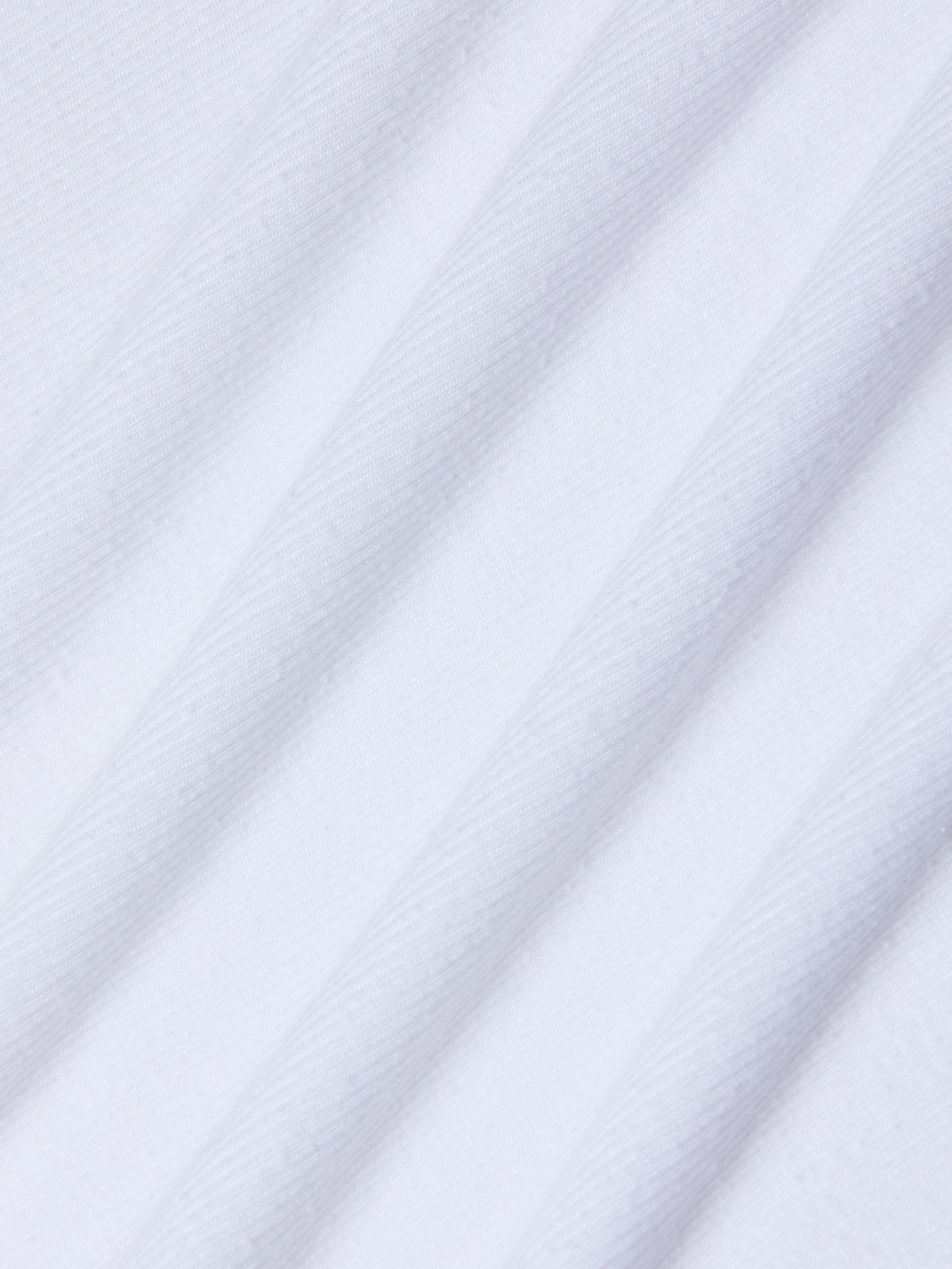 Close-up of the Nyra Bodysuit’s white stretch rib material, featuring diagonal, evenly spaced ridges that create a textured, striped pattern. The gentle sheen and soft feel of the fabric suggest comfort and versatility—ideal for minimalist styling or as a base layer.