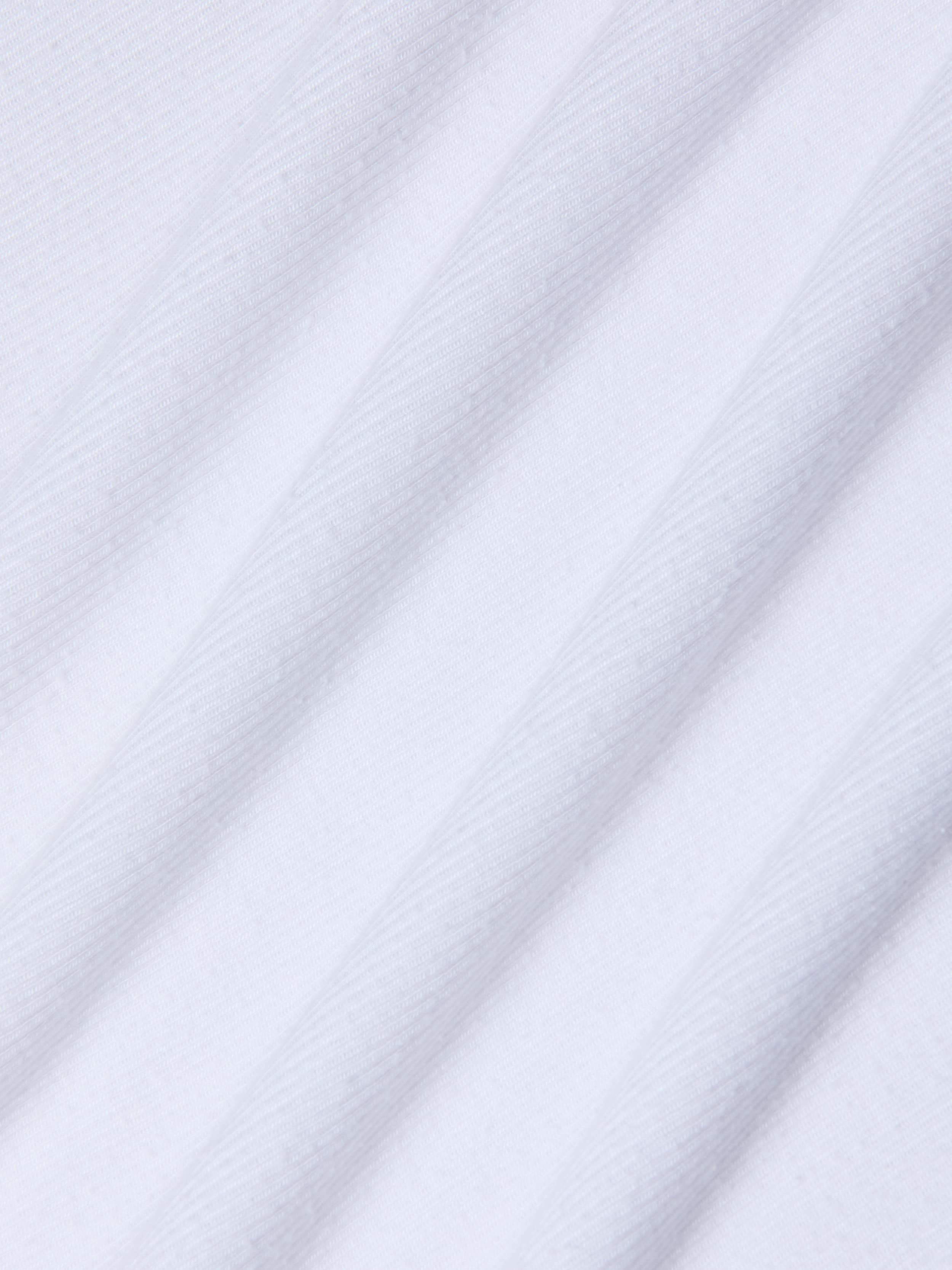 Close-up of the Nyra Bodysuit’s white stretch rib material, featuring diagonal, evenly spaced ridges that create a textured, striped pattern. The gentle sheen and soft feel of the fabric suggest comfort and versatility—ideal for minimalist styling or as a base layer.