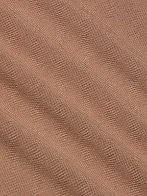 Close-up of the Wrenna Racerback Bodysuit’s light brown rib fabric, featuring diagonal textured lines that form soft ridges and shadows—showcasing the unique dimension and style of this standout piece.