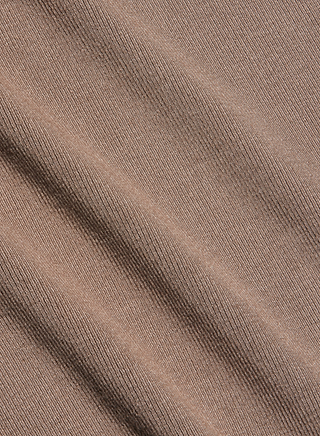 Close-up of the Lunara Camisole’s light brown ribbed fabric with diagonal folds, highlighting its fine knit texture—expertly crafted from ultra-soft micro modal for a smooth, comfortable feel.