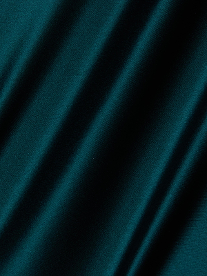 A close-up of the Akiya Satin Maxi Dress by L'AGENCE shows smooth, teal satin fabric with gentle diagonal folds from a bias cut, creating soft shadows and highlights across its surface.