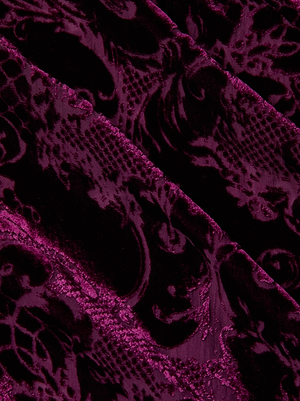 Close-up of the Christine Burnout Velvet Dress by L'AGENCE, featuring deep purple velvet with a raised floral and scroll pattern, diagonal seams, and a luxurious texture—perfect for a maroon gown or slip dress look.