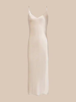 The Seridie Silk Slip Dress is a sleeveless, light beige satin slip dress with thin spaghetti straps, a V-neckline, and a flattering bias cut, shown on a plain beige background.