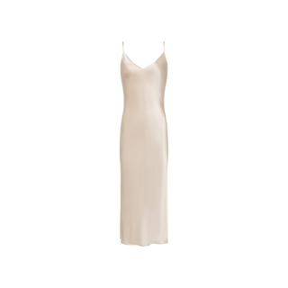 The Seridie Silk Slip Dress is a sleeveless champagne slip dress crafted from luxurious silk charmeuse, featuring thin spaghetti straps and a V-neckline, displayed against a white background.