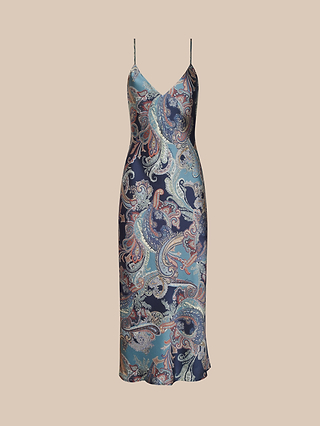 The Seridie Silk Slip Dress is a sleeveless, midi-length slip dress with thin straps, adorned with a blue, navy, and pink paisley print on a light background and cut on the bias for an effortlessly flattering drape.