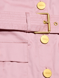 Close-up of the Noam Poplin Shirt Dress—a light pink utility jacket with a gold buckle belt, LAGENCE-stamped gold buttons, smooth fabric, and a front pocket.