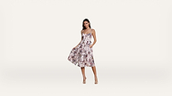 Woman wearing a sleeveless, floral print midi dress with a fitted bodice and flared skirt, standing in heels against a plain white background.