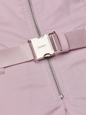 Close-up of a pink jacket with a metal zipper and buckle, featuring the brand 'Ganni'.
