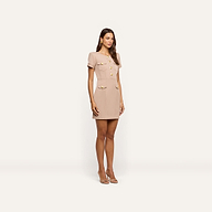 A woman wears the Cori Mini Dress, a structured, beige mini dress with short sleeves, a button-down front, gold-tone hardware, and two flap pockets on the chest.