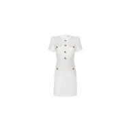 The Cori Mini Dress is a white, short-sleeved mini dress accented with gold-tone hardware on the front buttons as well as on its two chest and two hip pockets. Displayed against a plain white background, this dress features a structured fit that lends a polished touch to its classic silhouette.