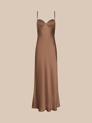 A Sayla Silk Gown with thin straps and a fitted bust, crafted in bronze satin and radiating vintage glamour, displayed against a pale beige background.