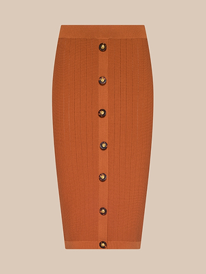 The Melania Pointelle Knit Skirt is a knee-length, ribbed orange pencil skirt with a body-skimming fit and a front row of dark round buttons, shown on a plain beige background.