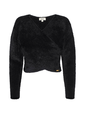 The Antonella Crossover Sweater by L'AGENCE is a black, fuzzy oversized V-neck with long sleeves, a wrap-style front, and a gold-tone tag at the hem for cozy-chic appeal.