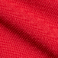 Close-up of lipstick red fabric from the Romona Knit Dress, featuring a visible woven texture and a slight diagonal fold that highlights the fine threads and vibrant color.