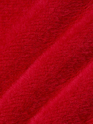 Close-up of the Guinevere Cropped Pullover's ultra-soft red knit fabric, featuring diagonal ridges and a textured, slightly fluffy surface.
