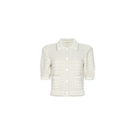 The Novalie Cardigan Top is a cream-colored, short-sleeve button-up textured cardigan featuring a grid pattern and a collar, displayed on a plain white background.