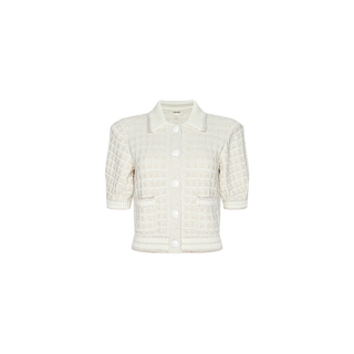 The Novalie Cardigan Top is a short-sleeve white button-up textured cardigan with a grid pattern, crafted from boucle yarn and featuring large white buttons and a collar, displayed on a plain white background.