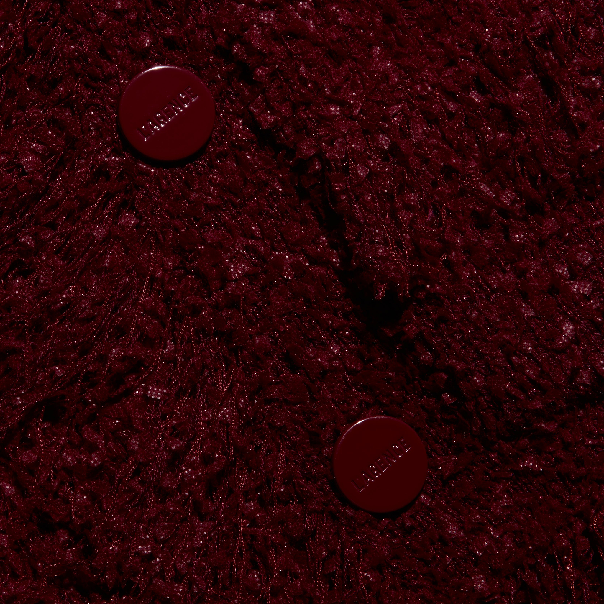 Mireille Fringe Cardigan in deep red, featuring a textured knit, fringed hem, and two matching round buttons.