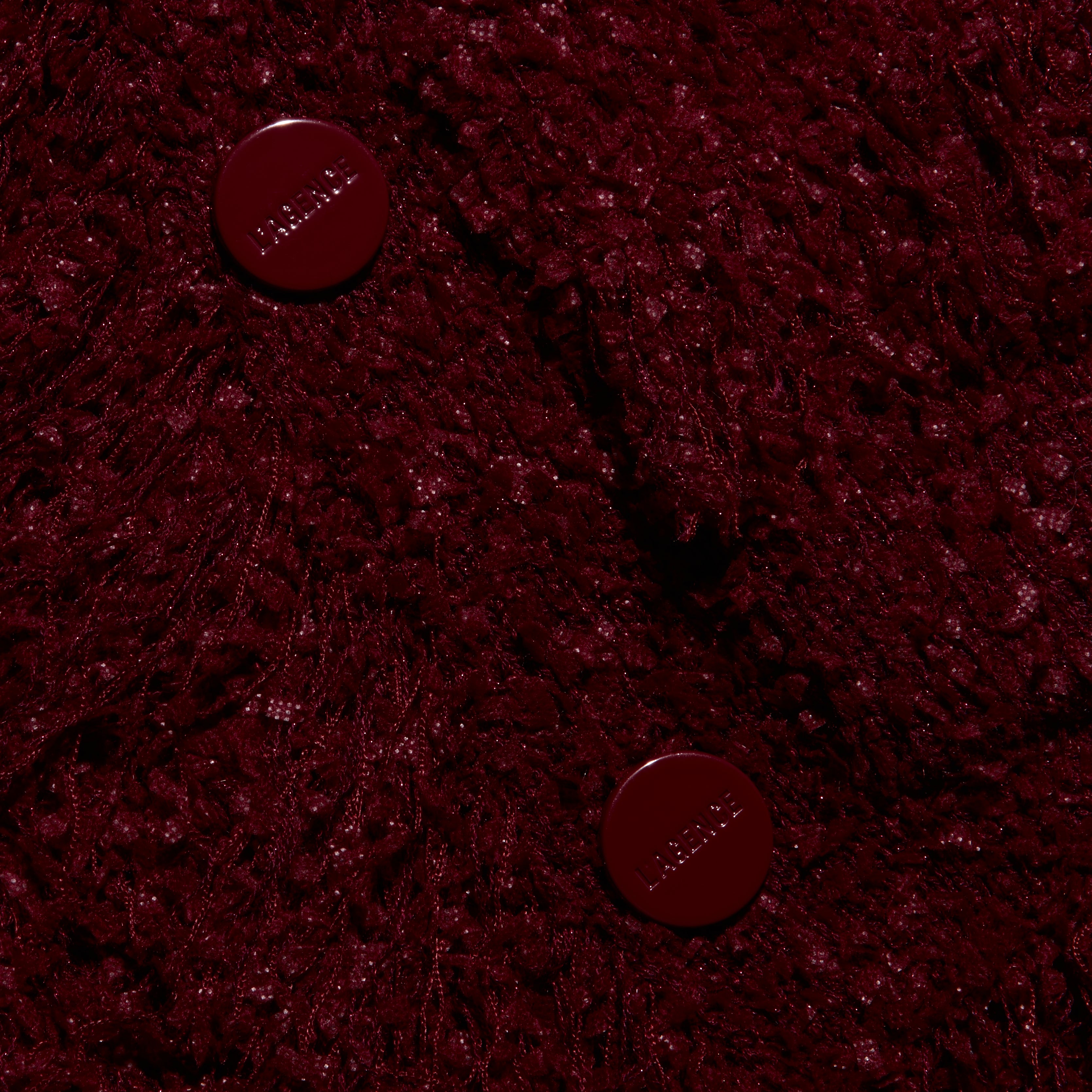Mireille Fringe Cardigan in deep red, featuring a textured knit, fringed hem, and two matching round buttons.