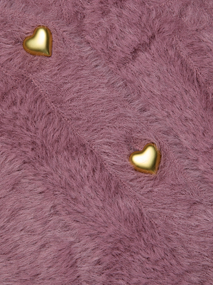 Two small, shiny golden heart-shaped objects rest on the soft, fuzzy knit pink Harriet Cardigan by L'AGENCE.