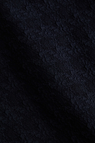 Close-up of the Alexandria Bikini Top in black, featuring textured bouclé fabric with subtle wavy patterns and a slightly raised, tactile surface.