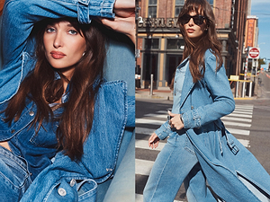 Woman wearing a blue denim jacket and coat in an urban setting.