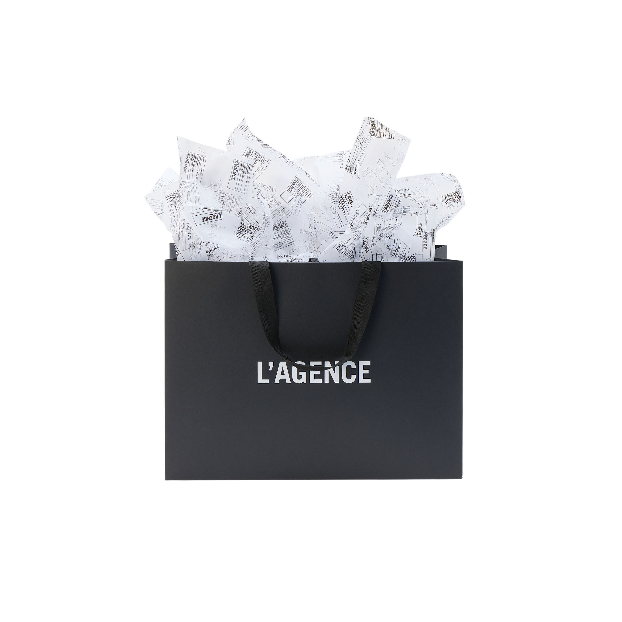 Large L’AGENCE Gift Bag with black ribbon handles and branded tissue paper overflowing from the top.