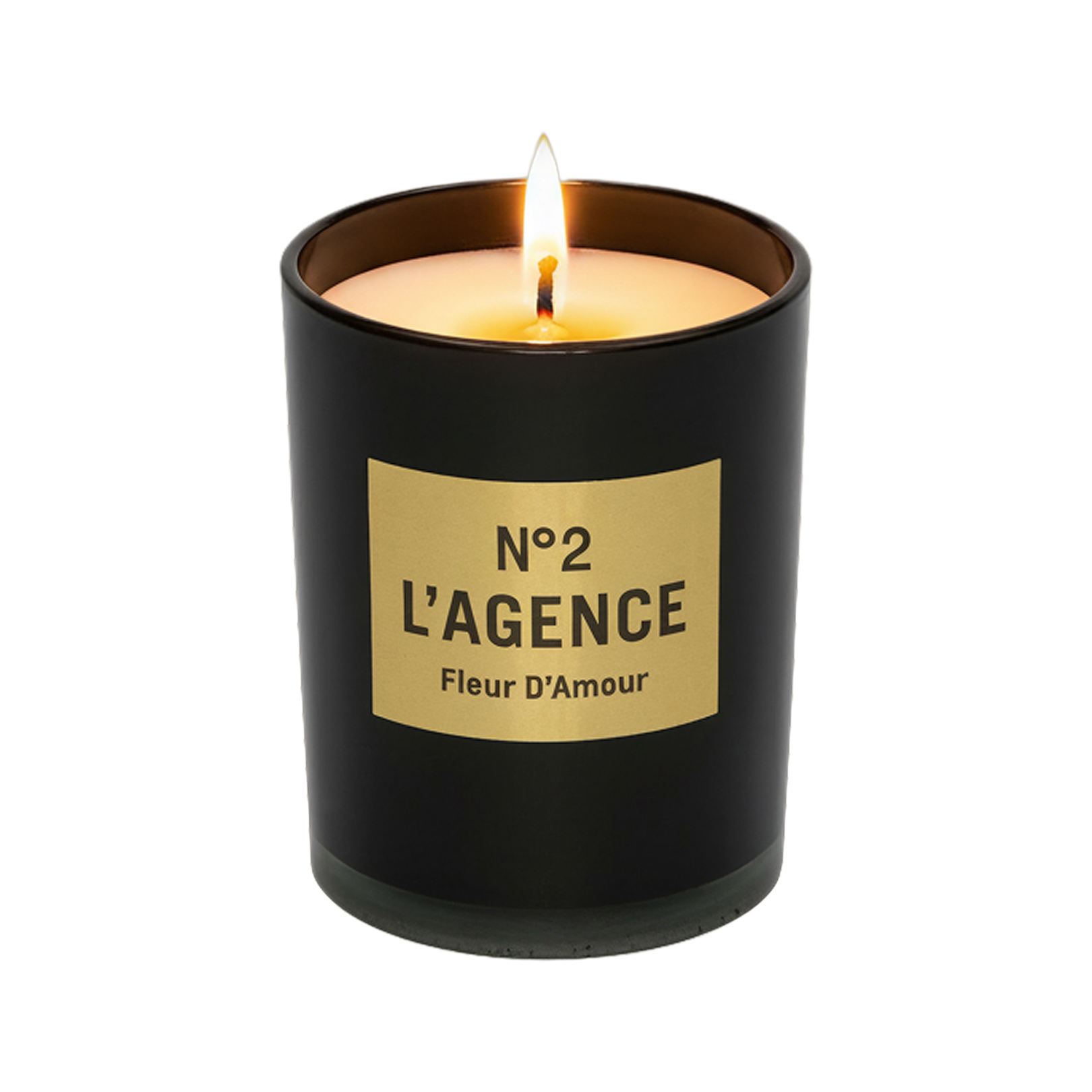 A lit Fleur D’Amour hand-poured candle in a black glass jar with a beige rectangular label is displayed against a white background, featuring a luxurious baccara rose scent.