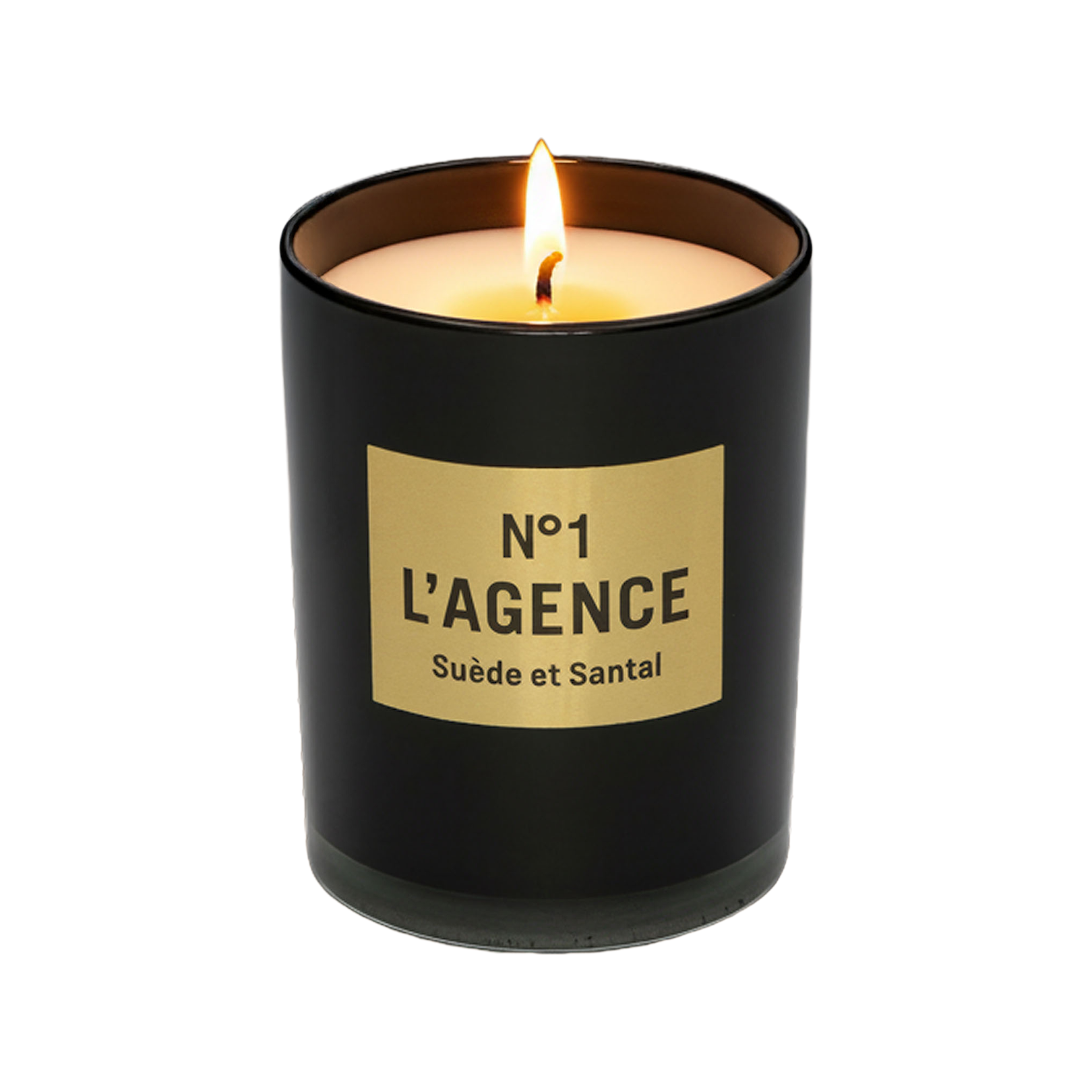 A lit Suède et Santal soy-blend candle in a sleek black glass holder with a beige label sits elegantly against a plain white background, capturing the sophisticated essence of Southern California.