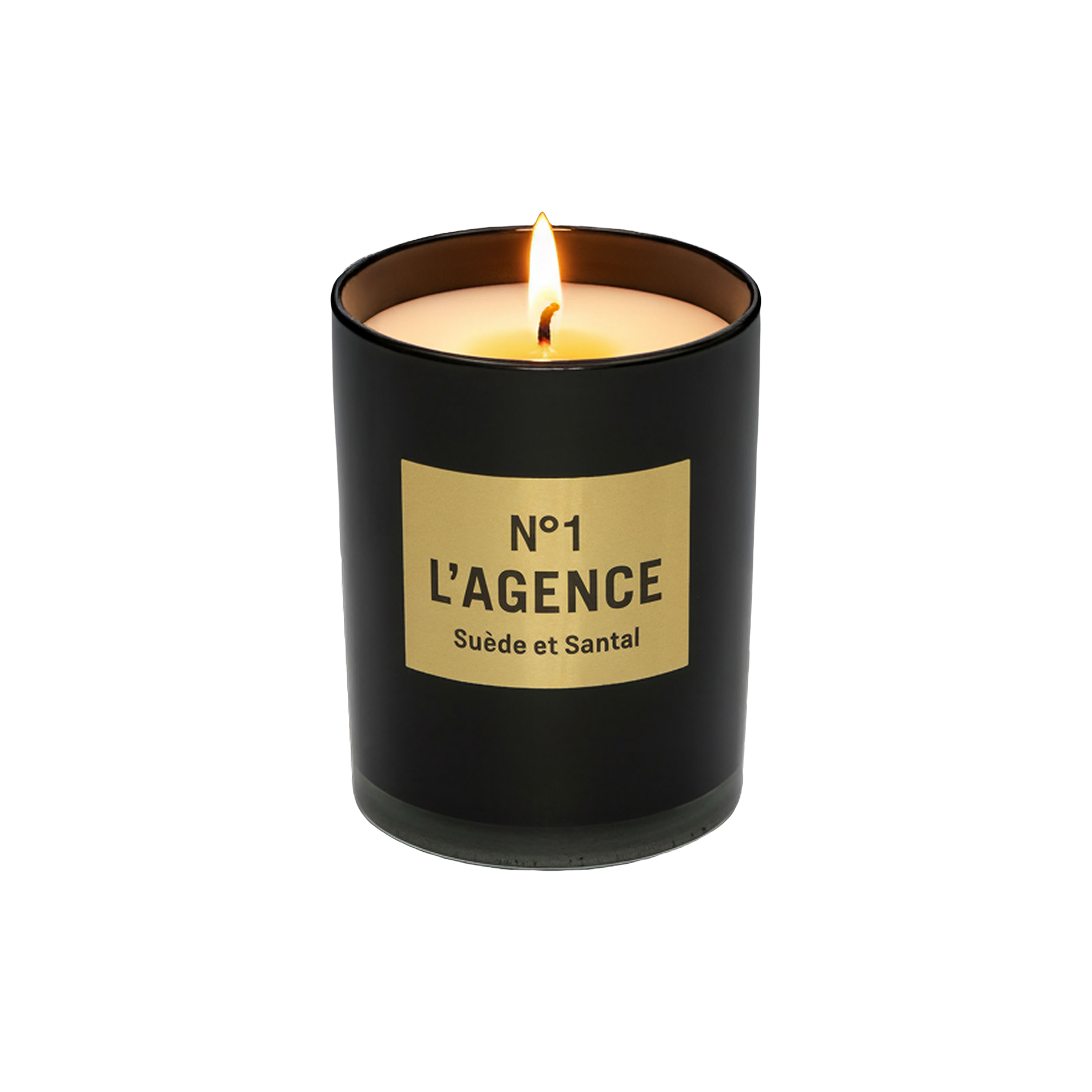 A lit Suède et Santal black sandalwood candle, crafted from soy-blend wax and housed in a glass jar with a beige label reading “No 1 LAGENCE Suède et Santal,” sits on a white background.