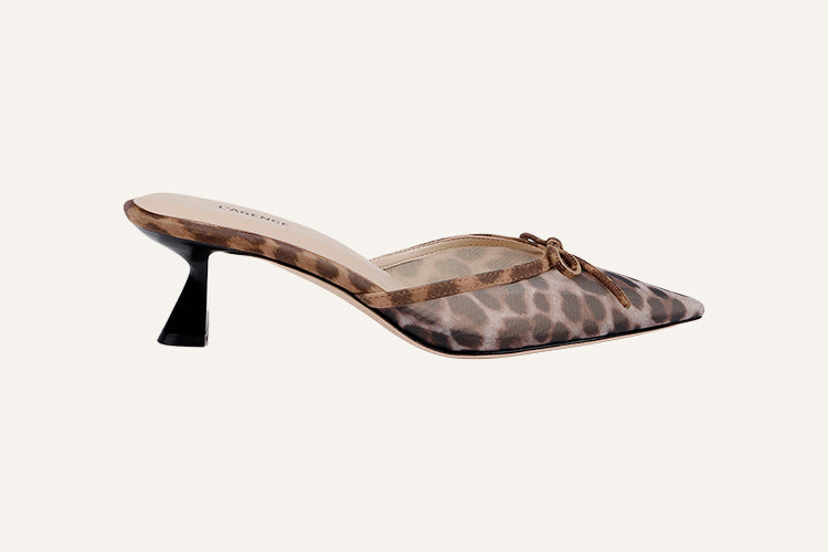Leopard print pointed-toe mule featuring a thin black kitten heel and a small bow on the toe.
