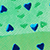 Close-up of a green surface with scattered blue and green heart shapes, creating a playful, patterned design.