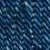 Close-up of blue denim fabric showing a detailed zigzag weave pattern, with varying shades of blue and visible texture in the threads.