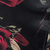 Black fabric featuring a red rose floral print.