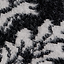 Close-up of a fuzzy black and white abstract animal print knit fabric.