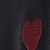A red heart applique centered on a black background.