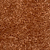 A close-up view of a textured brown surface resembling ground coffee or fine brown granules, with an uneven, slightly rough appearance.