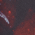 Abstract composition of blurred red and dark gray shapes.
